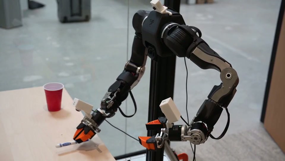 OpenArm bimanual robot performing a manipulation rollout at the General Intelligence Labs site
